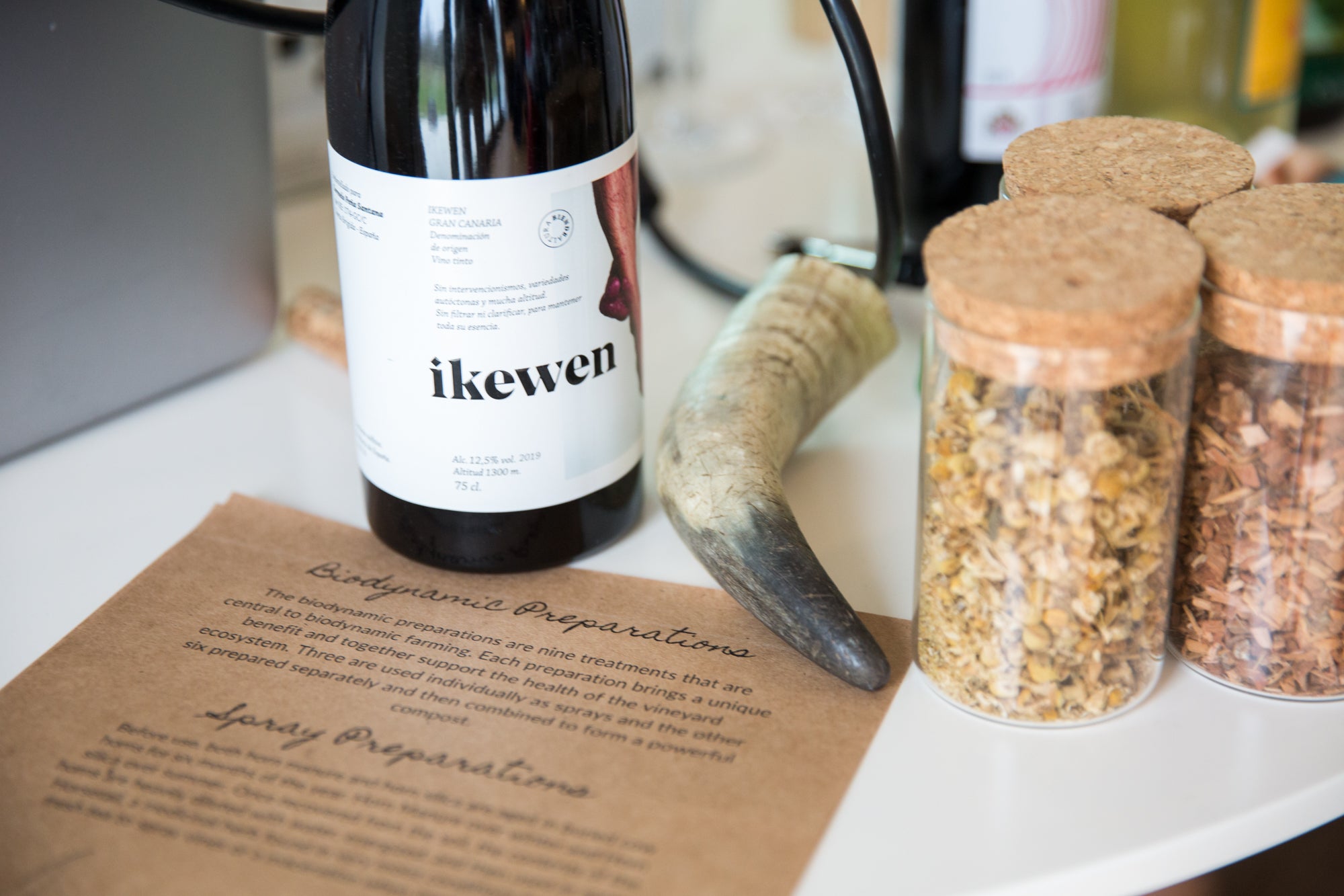 A selection of materials used to make biodynamic preparations and a bottle of natural wine